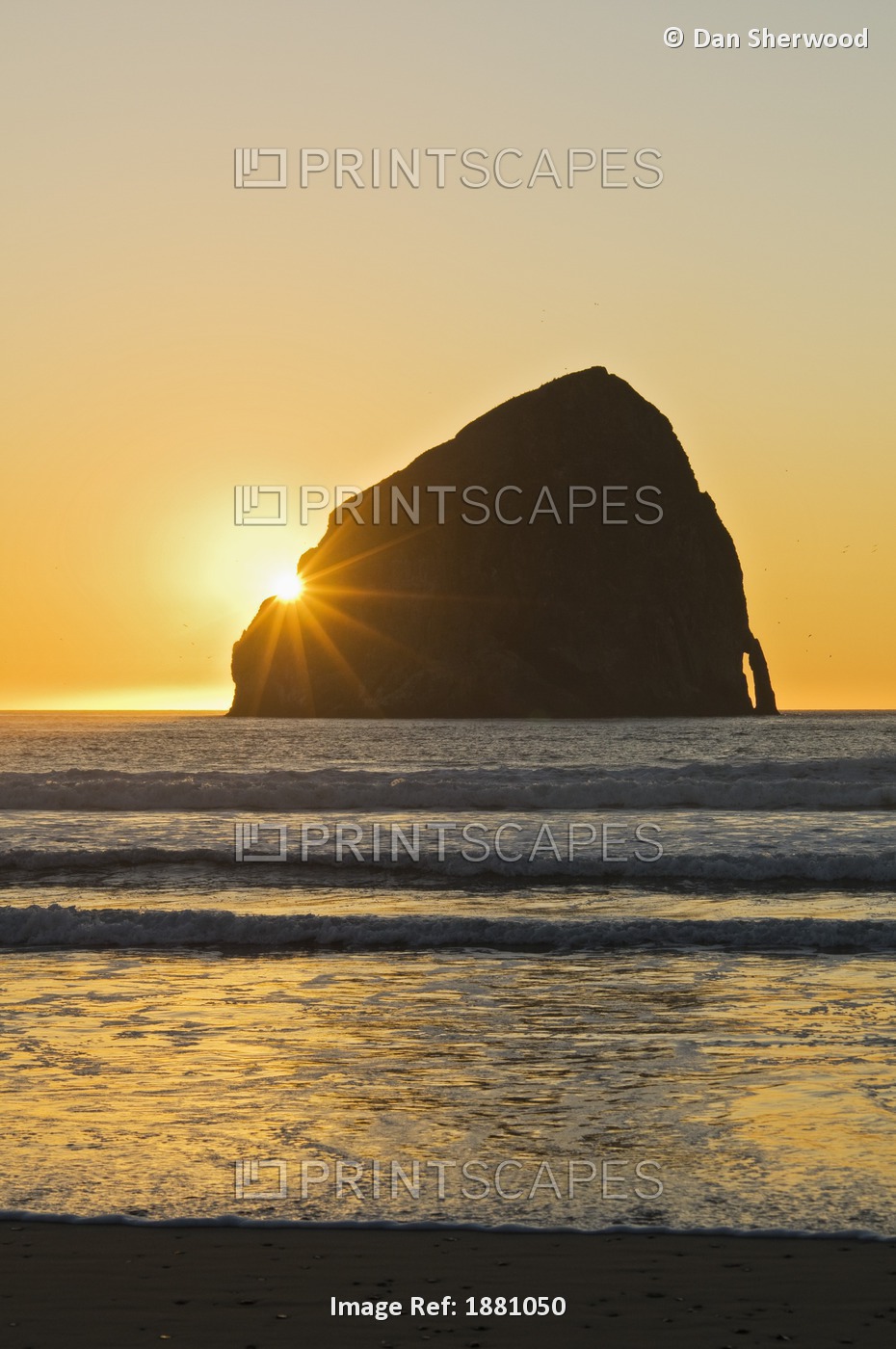 Sunburst Over Haystack Rock At Cape Kiwanda; Pacific City, Oregon, Usa